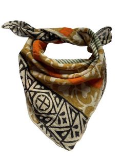 an orange and white bandana with geometric designs on the front, tied in a knot