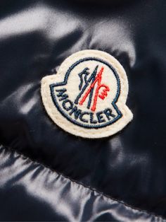 Moncler takes its name from the Alpine town of Monestier-de-Clermont and its collections are always built with those snowy conditions in mind. This 'Coutard' jacket is cut from glossy midnight-blue shell that's quilted and packed with insulating down. The sleeve is appliquéd with the house logo. Small to size. See Size & Fit notes. Designer Winter Outerwear With Logo, Designer Winter Outerwear With Logo Detail, Hooded Winter Outerwear With Logo Patch, Winter Outdoor Outerwear With Logo Patch, Classic Winter Outerwear With Logo, Classic Winter Outerwear With Logo Detail, Winter Hooded Outerwear With Logo Detail, Hooded Winter Outerwear With Logo Detail, Blue Winter Outerwear With Logo Patch