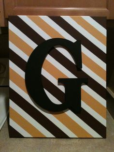 the letter g is made out of striped paper