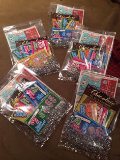 six packaged candy bags sitting on top of a bed