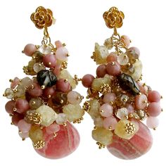 Fleurs XIX Earrings. Unique Missoni-style striped rhodochrosite briolettes in honeysuckle pink, bamboo, coffee liqueur and nougat colors are juxtaposed with generous clusters of champagne topaz, rhodonite, pink jade, rose quartz, raw Herkimer diamond nuggets, pink jade, andalusite and accented with a smokey quartz carved leaf. Each of the hundreds of cluster beads are poised on gold vermeil headpins and suspended from gold vermeil floral posts, to create this textural explosion. It is the glossy Cluster Bracelets, Earrings For Sale, Beads Bracelet Design, Pink Topaz, Quartz Cluster, Beaded Hoop Earrings, Watermelon Tourmaline, Antique Earrings, Quartz Rose