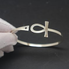 "Silver Ankh Bracelet is handmade with its own uniqueness. It can be bought as a gift for any occasion like birthday gift, wedding gift, travel gift, souvenir and etc. If you need rose gold plating or yellow gold plating, please contact us, we will advice you on the additional fees applicable. You can choose the stone color but it is subject to availability. Please convo us. Base Material: Sterling Silver Size / Depth: 19mm (Approximately) Stone: Black CZ Bangle wrist size: 6'' - 7.5''. Adjustab Symbolic Handmade Bracelets For Friendship, Adjustable Bangle Bracelet For Promise, Symbolic Handmade Friendship Bracelets, Symbolic Adjustable Promise Jewelry, Adjustable Spiritual Cuff Bracelet For Friendship, Adjustable Symbolic Bangle Bracelet, Handmade Silver Promise Bracelets, Spiritual Friendship Cuff Bangle Bracelet, Handmade Adjustable Spiritual Bangle