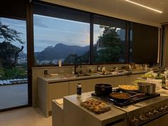 a kitchen filled with lots of food and cooking utensils on top of a counter