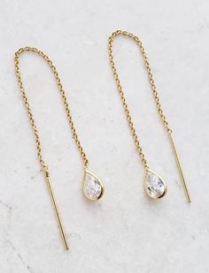 Add a chic accent to your wardrobe with these beautiful bezel crystal pear shape threader earrings in clear color. Stylish yet so classic for everyday wear. Size: 3" long Gold over sterling silver threader earrings Clear tiny pear shape crystals This product was made by one of our partner companies. Elegant Adjustable Teardrop Earrings, Formal Long Drop Threader Earrings With Delicate Chain, Elegant Hypoallergenic Teardrop Threader Earrings, Elegant Teardrop Threader Earrings, Elegant Everyday Teardrop Threader Earrings, Elegant Teardrop Threader Earrings For Everyday, Minimalist Teardrop Threader Earrings With Adjustable Chain, Classic Long Drop Threader Earrings, Elegant Sterling Silver Teardrop Threader Earrings