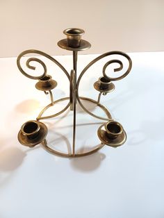 a metal candle holder with four candles on it