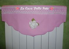 a pink table cloth with white flowers on it and the name la casca delle fate