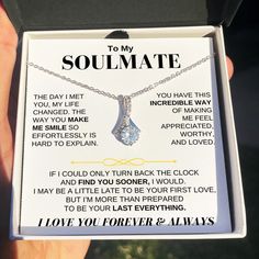 a person holding up a necklace with the words to my beautiful wife on it