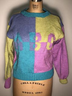 Hand made item from the 80’s with a tag still attached. This is a hand made sweater. There are no tags other than the one attached Tag size 6Measurements laying flat 16” pit to pit 20” length Vintage Multicolor Acrylic Sweater, Retro Knitted Acrylic Sweater, 90s Style Purple Sweater For Fall, 90s Style Purple Fall Sweater, Retro Multicolor Acrylic Sweater, Vintage Multicolor Knitted Sweater, 90s Purple Winter Sweater, 90s Style Multicolor Cotton Sweater, Vintage Multicolor Hand-knitted Sweater