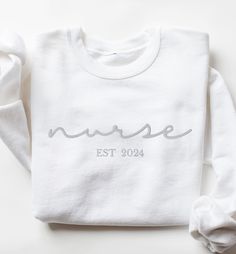 These unisex cozy sweatshirts (we use Gildan) are embroidered "nurse" in cursive font and your custom year in your choice of thread color 😀 * 50% cotton, 50% polyester * Pre-shrunk * Classic fit * 1x1 athletic rib knit collar with spandex * Air-jet spun yarn with a soft feel and reduced pilling * Double-needle stitched collar, shoulders, armholes, cuffs, and hem SIZING: Please ensure you check measurement chart before ordering as shirts are printed once you place your order. Sweatshirts are unisex sizes but they fit true to size for ladies. Please size up if you want a roomier fit. If you have any questions about sizing, please feel free to ask! We'd love to help :)  DESIGN: Embroidered CARE: Wash inside out in cold water and hang to dry or dry in gentle cycle. Do not iron or if you must, White Letter Embroidery Sweatshirt For Loungewear, White Sweatshirt With Letter Embroidery For Loungewear, White Sweatshirt With Letter Embroidery For Everyday, White Everyday Sweatshirt With Letter Embroidery, White Sweatshirt With Letter Embroidery, Cotton Relaxed Fit Nursing Sweatshirt, Cotton Nursing-friendly Relaxed Fit Sweatshirt, Cotton Sweatshirt For Nursing In Fall, White Relaxed Fit Sweatshirt For Nursing