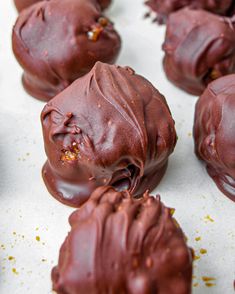 chocolate covered doughnuts sitting on top of a table