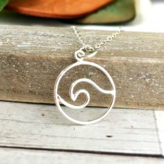 "Save 25% off your next purchase, sign up here: www.justjaynes.com/sign-up Wave Necklace. This ocean necklace features a rolling wave of sterling silver. Add a modern touch of beachy vibes to your look with this fun and curvy nautical jewelry. Silver wire is hand-formed into this playful shape, creating a gorgeous and fluid wave. The perfect charm for any beach lover! LISTING IS FOR: - One sterling silver charm necklace. --------------------------------------------------------------------- FEATU Silver Beach Charm Necklaces For Summer, Silver Summer Beach Charm Necklaces, Summer Beach Silver Charm Necklaces, Silver Charm Necklaces For Summer Beach, Minimalist Sterling Silver Jewelry For Beach, Adjustable Wavy Sterling Silver Jewelry, Sterling Silver Wavy Necklace For Gifts, Silver Wavy Necklace For Gift, Silver Wire Wrapped Ocean-inspired Jewelry