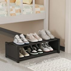 there are many pairs of shoes on the shelf