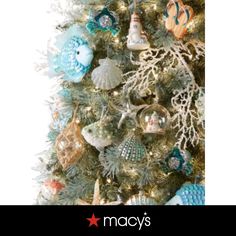 a christmas tree decorated with ornaments and seashells is featured in the macy's holiday catalog