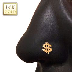 a close up view of the nose and side of a person's head with gold dollar signs on it