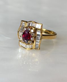 "Ruby Diamond Ring, Ruby Ring, Vintage Ruby Ring For Women, Oval Ruby, Vintage Ruby Engagement Ring, Ruby Right Hand Ring, Vintage Jewelry Say \" I love you\" with this delicate and feminine traditional oval ruby ring with meticulous detailing. This 18k yellow gold ring features a true red oval ruby weighing 0.61 carats surrounded by a shining halo of round diamonds which is also surrounded with sparkling baguette diamonds in a beautiful lattice pattern. the total diamond weight is: 0.69 carats. Oval Ruby Ring, Dainty Earrings Studs, Vintage Ruby Ring, Ruby Engagement Ring Vintage, Engagement Ring Ruby, Antique Emerald Ring, Ruby Ring Vintage, Vintage Sapphire Ring, Ruby Diamond Ring