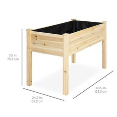 a wooden planter sitting on top of a white floor next to a measuring line