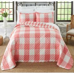 a red and white checkered bedspread with pillows