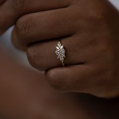 a woman's hand with a diamond ring on it