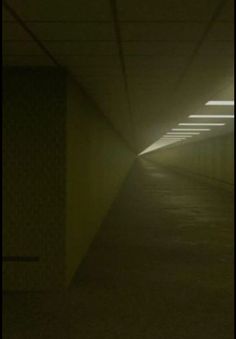 an empty tunnel with light at the end and no one in it on the other side