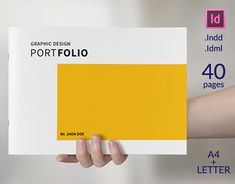 a person holding up a book in their hand with the title graphic design portfolio on it