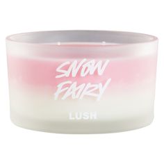 a pink and white candle with the words snow fairy printed on it's side