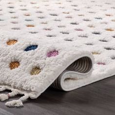 a white rug with multicolored circles on it