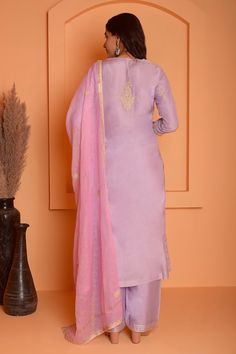 Lilac kurta featuring dori embroidered floral and paisley motifs highlighted with gota lace embellishments. Comes with palazzo and dupatta.
Components: 3
Pattern: Embroidered
Type Of Work: Floral, Gota, Dori
Neckline: Round
Sleeve Type: Three quarter
Fabric: Cotton Silk
Color: Purple
Other Details: 
Length:
Kurta: 47 Inches
Palazzo: 38 Inches
Dupatta: 2.5 Mtr 
Occasion: Sangeet,Mehendi and Haldi - Aza Fashions Elegant Art Silk Salwar Kameez With Embroidered Border, Elegant Purple Salwar Kameez With Floral Embroidery, Elegant Purple Sets With Embroidered Border, Elegant Embroidered Banarasi Silk Kurta, Wedding Kurta With Embroidered Banarasi Silk, Elegant Banarasi Silk Dupatta With Embroidered Border, Wedding Cotton Silk Salwar Kameez With Embroidered Border, Purple Palazzo Set With Floral Embroidery For Wedding, Purple Floral Embroidery Palazzo Set For Wedding