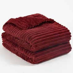 three red blankets stacked on top of each other