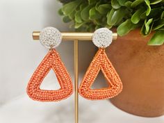 "Tennessee Vols Beaded Earrings | Orange and White Geometric beaded statement earrings are the perfect addition to any UT gameday outfit.  Oh, Rocky top! Jazz up your game day look with a fun pop of school spirit!  Perfect for Tennessee Volunteer fans!🧡  Incredibly lightweight and easy to wear, the beaded statement earrings are made from acrylic seed beads with a felt backing and can take you from tailgate to after-party with ease.   These earrings also make the perfect gift for graduation, college student, tailgate hostess, birthdays and more.🎁 SIZE: Approx 2\"l x 1 1/2\"w FREE SHIPPING when you spend $35 or more! Made from acrylic seed beads with a felt backing, very lightweight.   Posts are lead and nickel-free. FOLLOW along on Instagram @OhPoppyStyle for new arrivals, giveaways and e Ut Gameday Outfit, Graduation College, Wrap Too, Gift For Graduation, Tennessee Vols, Rocky Top, Franklin Tn, Tennessee Volunteers, Earrings Beaded