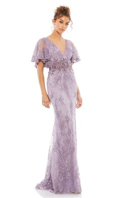 a woman in a long purple dress with an open back and ruffled sleeves, posing for