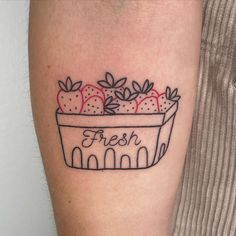 a tattoo with strawberries in a flower pot on the arm that says fresh and is black ink