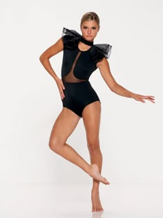 a woman in a black leotard posing for the camera