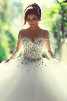 a woman in a white wedding dress is posing for the camera