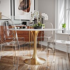 a dining table with clear chairs around it