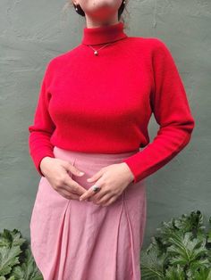 * This is a truly lovely sweater. It is 75% Lambswool, 15% angora, and 10% nylon. It is really soft, cozy, warm, and fluffy. The drop shoulder design is so flattering and feminine. The soft shoulders are nicely constrasted with the structured mock/turtle neck collar. It is not cropped, but on the shorter side of a full length sweater. Perfect for tucking into bottom without too much bulk.  * Measurements (inches/flat) Shoulder to shoulder - armpit to armpit - 19.5 Canter front length - 20 Waist Solid Wool Tops For Winter, Wool Funnel Neck Top For Winter, Red Wool Sweater For Workwear, Red Wool Sweater For Work, Cozy Fitted Wool Turtleneck, Fitted High Neck Wool Sweater, Casual Fitted Red Turtleneck, Soft Knit Wool Tops, Casual Red Fitted Turtleneck