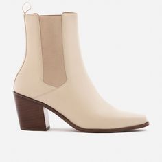 A unique Chelsea boot. Inspired by cowboy boots and western styling, the Bianca Chelsea Boots kick things up a few notches. The semi square toe box, alluring Cuban heel and sculptural shape create a captivating silhouette that will attract the right kind of attention. With a contemporary look and feel, the Biancas love to have fun, and play well with your casual outfits and dressy ensembles. Go ahead, take them for a whirl. This product is made from Gold Rated full-grain calfskin leather sourced Spring Stacked Heel Snip Toe Boots, Western Mid-calf Boots With Stacked Block Heel, Western Ankle Boots With Heel Pull Tab, Western Style Mid-calf Boots With Block Heel, Square Toe Boots With Sculpted Heel For Fall, Fall Moto Boots With Stacked Heel And Square Toe, Fall Boots With Sculpted Heel And Square Toe, Western Leather Chelsea Boots For Spring, Western Boots With Sculpted Heel For Fall