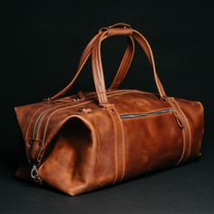 A travel bag is an element of the wardrobe of men and women who go on business trips, short-term vacations, and short weekend trips. The Stout bag will store all your clothes and perfectly complement your look. This leather travel bag impresses with its appearance thanks to the natural material and metal fittings: Spacious and functional, roomy. With a large volume of 34 liters, you will find a place for everything you need to take with you: clothes, shoes, cosmetics, appliances, personal care products, accessories and much more. Durability and reliability. The bag is made of dense and high-quality genuine leather, which makes it extremely durable. You can be sure that it will serve you for many years, remaining in perfect condition. Protection from external factors. The travel bag for men Classic Leather-lined Luggage For Weekend Trips, Classic Large Capacity Duffle Bag For Trip, Weekend Travel Tote With Leather Lining, Leather Travel Accessories With Luggage Sleeve For Weekend Trips, Leather Lined Tote Travel Bag For Overnight Trips, Leather-lined Tote Travel Bag For Overnight Trips, Classic Satchel Travel Bag For Trips, Classic Travel Luggage With Leather Backing, Leather Travel Bag For Weekend Trips