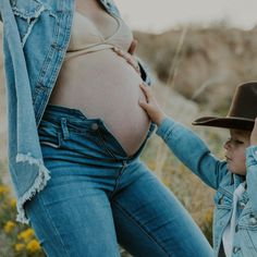 a woman holding the belly of a child