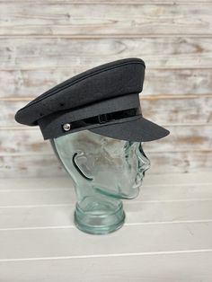 This is high quality professional Chauffeur Hat/Pilots Hat for that extra special finishing look for your driver. From the classic Roll's to a more modern car to a private jet,  the hats add the look and style to help you look the part. The hat is carefully made from Polyester with a black patent strap across the front Size 57cm Colour Grey with Black lining Fitted Six-panel Winter Hat, Fitted Winter Six-panel Hats, Classic Six-panel Hat For Formal Occasions, Classic Six-panel Formal Hat, Classic Formal Six-panel Hat, Classic Six-panel Hat, Classic Winter Hat With Visor, Classic Winter Visor Hat, Formal Fitted Six-panel Hat