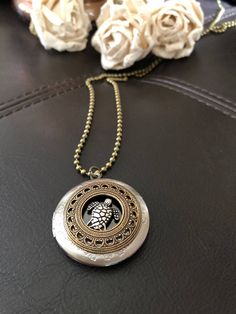 "🔸🔸orders are delayed by a few days this week. Thank you for your patience Sea turtle locket, ocean jewelry, turtle gift This antiqued silver locket has been adorned with an antiqued silver sea turtle setting inside a detailed antiqued silver bezel. This small folding spring locket is 1\" and can hold four small 3/4\" photos and hangs from 20\" of antiqued silver textured rhodium chain and lobster clasp. You can also purchase additional chain by the inch for a longer necklace during checkout. Spiritual Turtle-shaped Jewelry Gift, Spiritual Turtle Shaped Jewelry Gift, Unique Adjustable Locket Jewelry, Antique Silver Adjustable Locket Jewelry, Adjustable Antique Silver Locket Jewelry, Sea Turtle Necklace, Turtle Jewelry, Turtle Gifts, Silver Sea