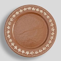 a brown plate with an intricate design on it