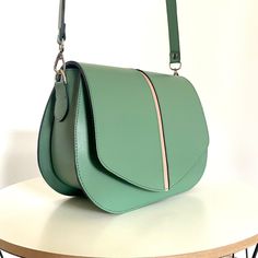 This leather bag, like all the others, uses our original ideas and handicrafts  Stylish and modern women handbag - Lamponibags. 🔥 Made of high quality smooth Italian leather in light green color. Lining made of natural Italian velor. Great combination inside and outside. The color scheme is perfect for a spring or summer look. 🔺Type: saddle bag, crossbody bag 🔺Size: 24 * 18 * 9cm (9,5x7,1x3,54 inches) 🔺Belt Length: 120cm (47,25 inch) This model can be made in different colors of genuine leat Green Handbag, Leather Saddle Bags, Belt Length, Bag Green, Leather Bag Women, Women Handbag, Modern Women, How To Make Handbags, Saddle Bag