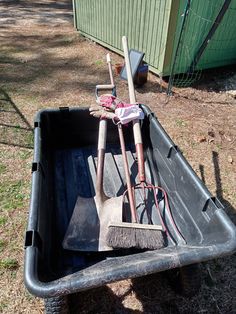 there are two shovels and a rake in the back of a dump truck bed