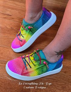 Lighten your step and slip into comfort and style with custom colored HEY DUDE Cody style sneakers! Hand-colored with a beautiful meld of bright rainbow tones, these gorgeous shoes will turn heads! With the eyelet upper and rainbow elastic laces plus beads for a secure fit, this Cody sneaker is one of cutest and comfiest shoes out there. With a removable memory foam insole and this shoe offers ergonomic comfort and cushioning, the ultralight outsole sets you free to explore in comfort and style! Casual Low-top Custom Sneakers With Elastic Laces, Casual Custom Low-top Sneakers With Elastic Laces, Sporty Multicolor Slip-on Sneakers With Round Toe, Trendy Multicolor Lace-up Custom Sneakers, Trendy Multicolor Sneakers With Vulcanized Sole, Trendy Multicolor Custom Sneakers With Round Toe, Trendy Multicolor Custom Sneakers For Spring, Trendy Multicolor Slip-on Sneakers, Colorful Casual Lace-up Sneakers