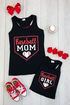 two matching baseball mom and baby shirts with red bows on the floor next to them