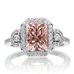 an engagement ring with a fancy pink diamond in the center and white diamonds around it