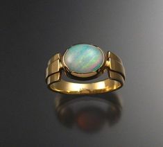 8x10 mm natural solid Brazilian Opal. Excellent fire contained in this crystal matrix stone. Bezel set opal and tapered comfort band. Size 8 3/4.