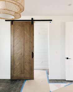 a room with white walls and wooden doors