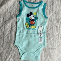 Jumping Beans Baby Beans Disney Mickey Mouse 6 Months Bodysuit New With Tags Blue Sleeveless Cotton Bodysuit, Blue Onesie With Character Print For Playtime, Playtime Blue Onesie With Character Print, Blue Character Print Onesie For Playtime, Playful Blue Onesie With Cartoon Print, Blue Cotton Onesie With Character Print, Playful Blue Cotton Bodysuit, Playful Blue Sleeveless Bodysuit, Cute Blue Sleeveless Bodysuit