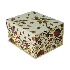 a white box with autumn leaves and birds on it's lid is sitting in front of a white background